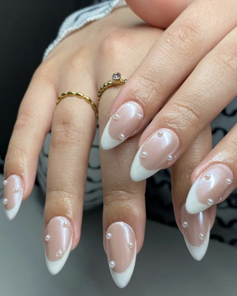 Nude nails with a french tip and pearls 